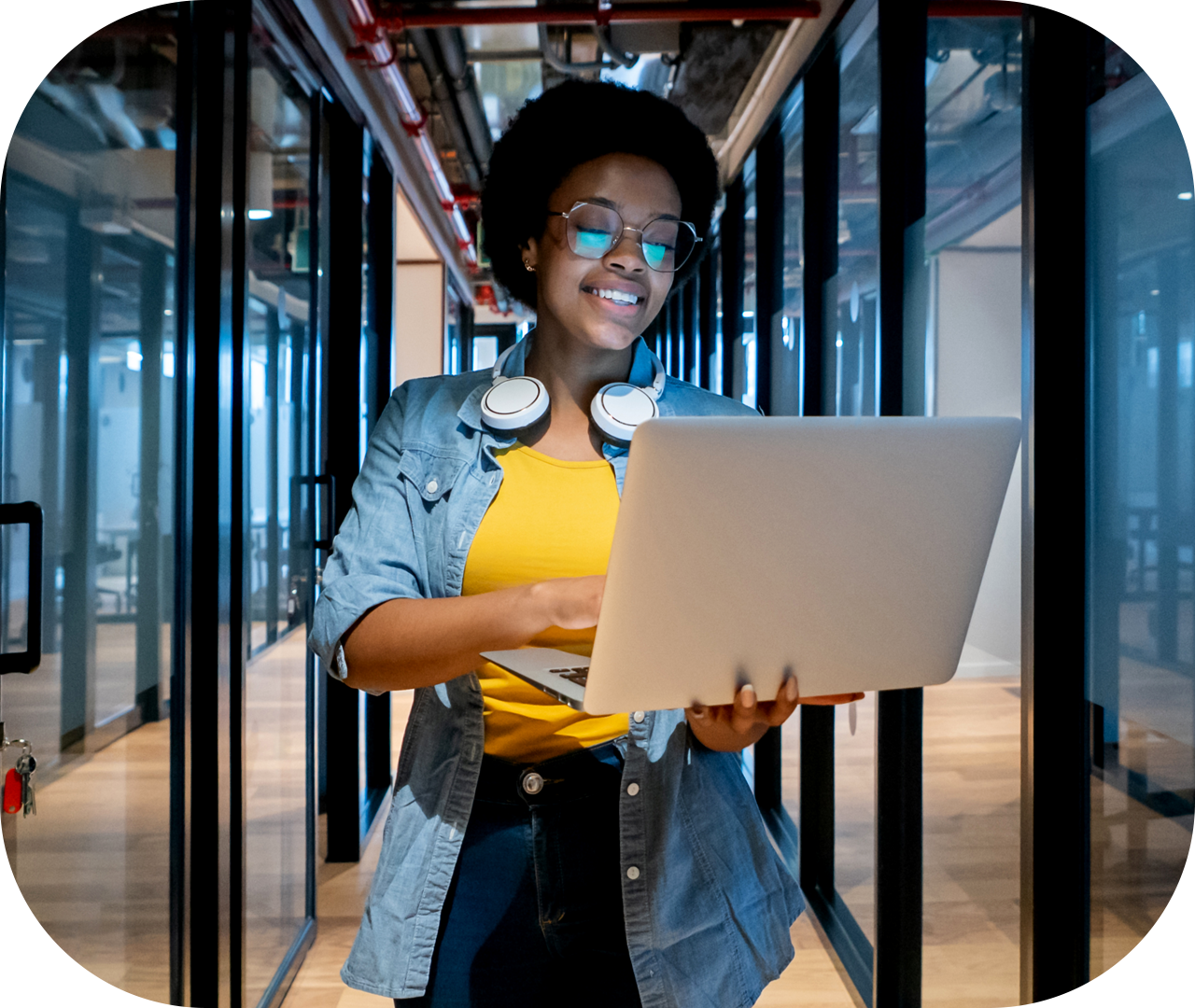 Happy-IT-technician-working-at-the-office-using-her-laptop-mainpage Happy-IT-technician-working-at-the-office-using-her-laptop-mainpage